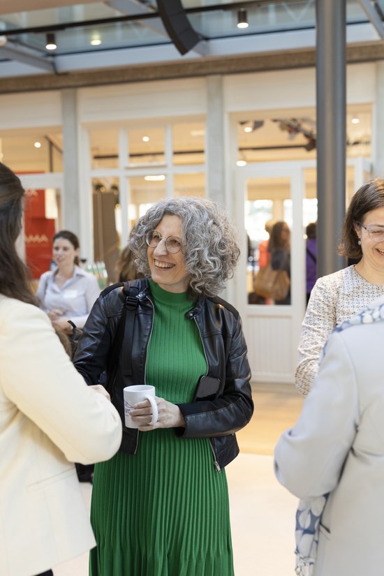 Adult,  Coat,  Cup,  Female,  Glasses,  Jacket,  Long Sleeve,  People,  Person,  Woman